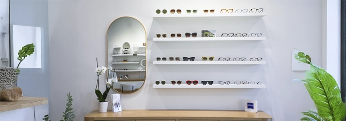 clean, modern optical display featuring neatly arranged eyewear frames and minimalist interior décor.