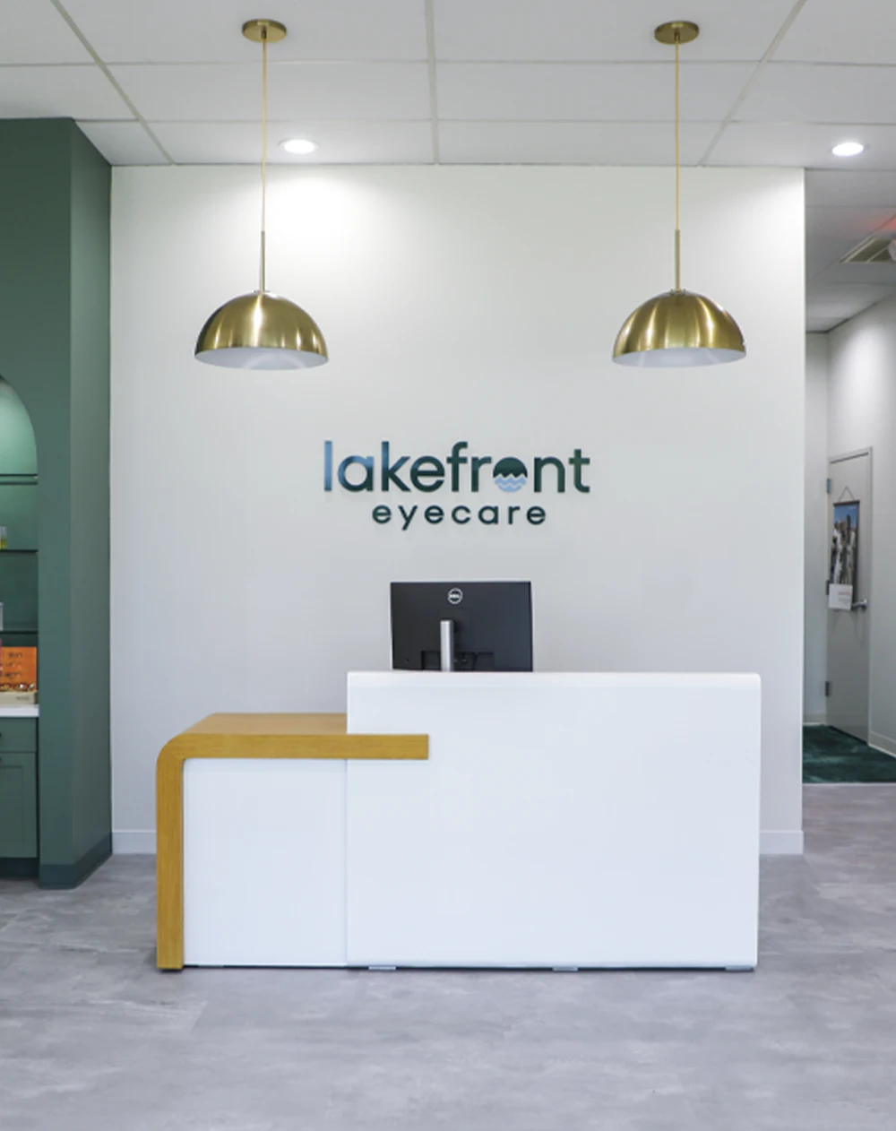 The reception area presents a modern, welcoming design with branded eyecare.