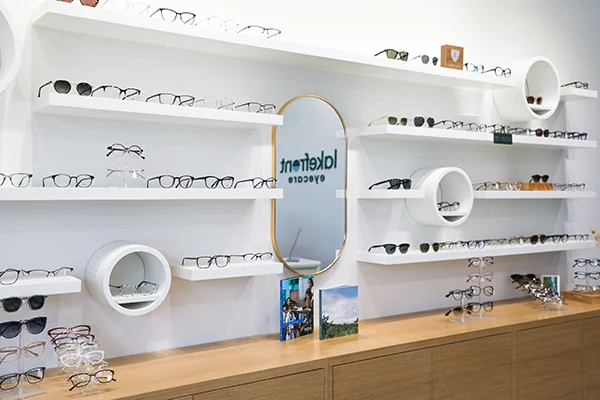 A curated eyewear display features a wide selection of frames in a modern, clean layout.