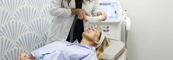 Dr. Melissa Dugan, OD performs a professional IPL treatment during an in-office eye care procedure.