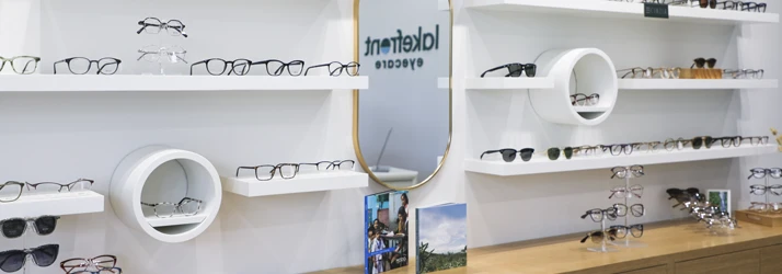 A curated eyewear display features a wide selection of frames in a modern, clean layout.